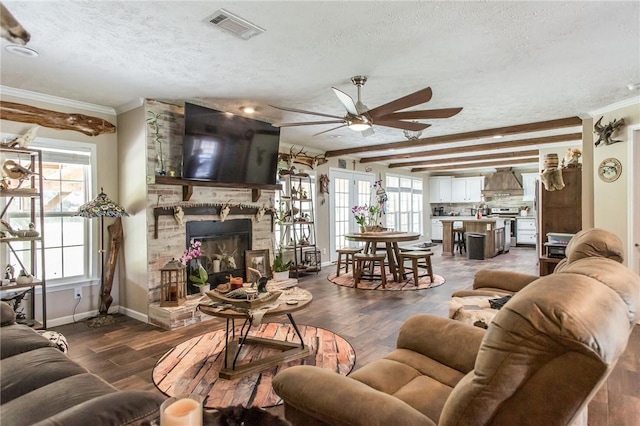 5618 Bowen Rd, Blackshear, GA 31516 - living room with a textured ceiling, ceiling fan, crown molding, a stone fireplace, and wood finished floors