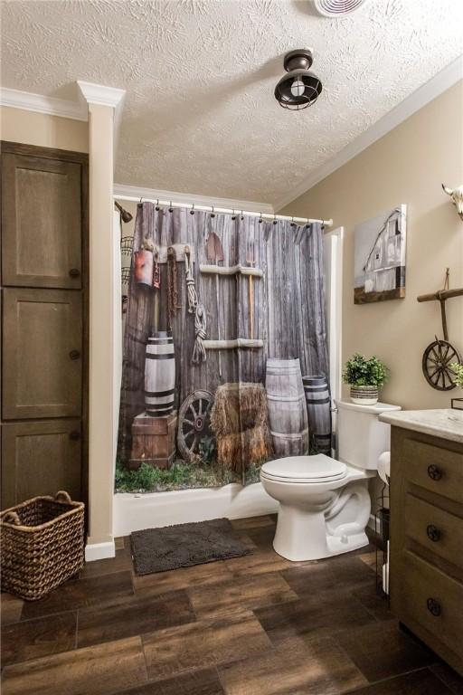 5618 Bowen Rd, Blackshear, GA 31516 - full bathroom featuring crown molding, a textured ceiling, vanity, and wood finished floors