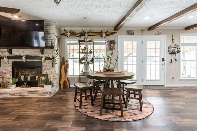 5618 Bowen Rd, Blackshear, GA 31516 - dining space featuring beam ceiling, wood finished floors, plenty of natural light, ornamental molding, and a fireplace