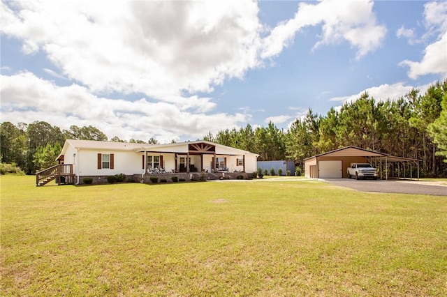 5618 Bowen Rd, Blackshear, GA 31516 - ranch-style house with a front yard, asphalt driveway, and a detached garage