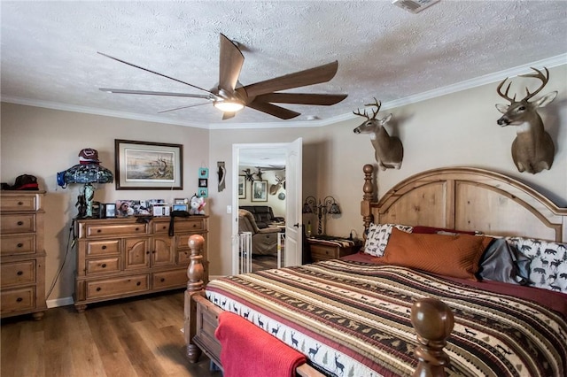 5618 Bowen Rd, Blackshear, GA 31516 - bedroom featuring dark wood-type flooring, ceiling fan, ornamental molding, and a textured ceiling