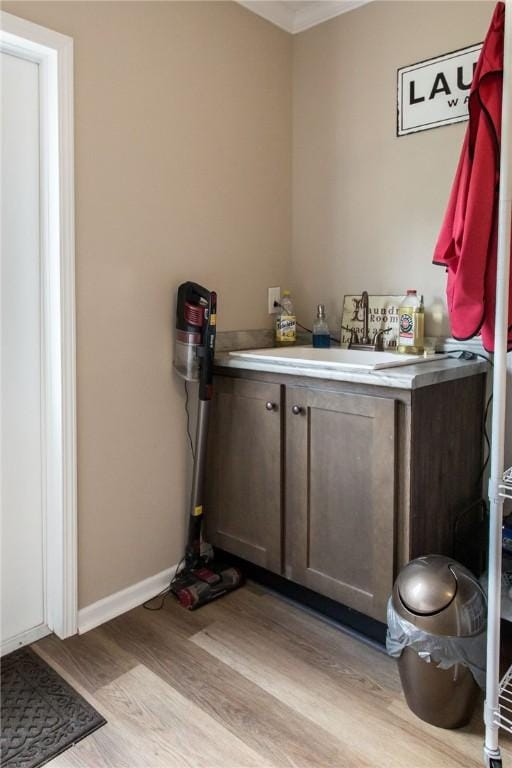 5618 Bowen Rd, Blackshear, GA 31516 - bathroom with wood finished floors, crown molding, and vanity