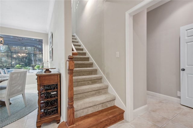 stairway featuring tile patterned floors and ornamental molding