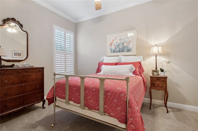 carpeted bedroom with ceiling fan and ornamental molding