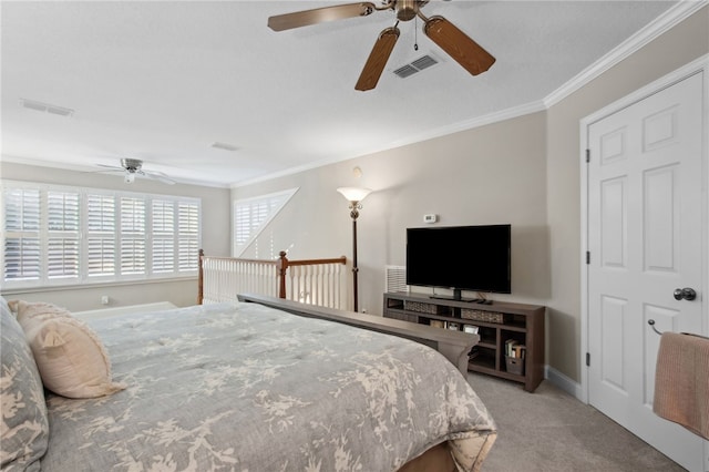 carpeted bedroom featuring ceiling fan and crown molding