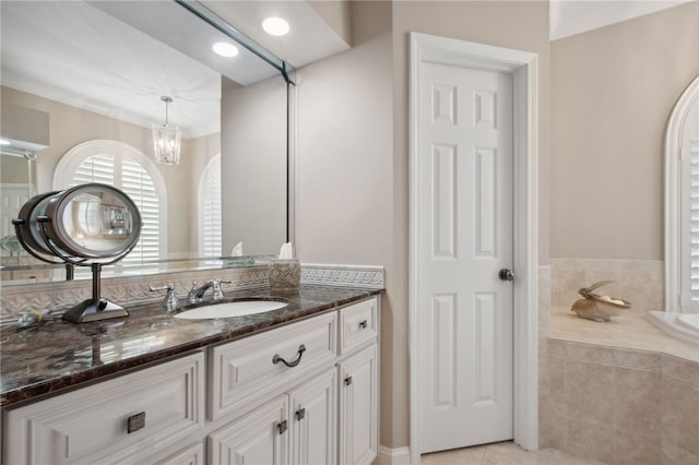 bathroom with a chandelier, vanity, and tile patterned flooring