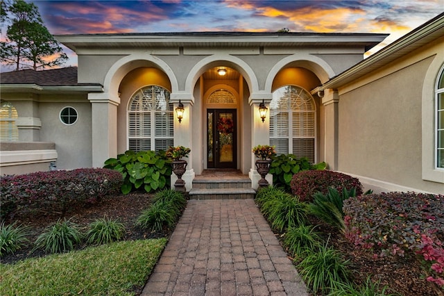 view of exterior entry at dusk