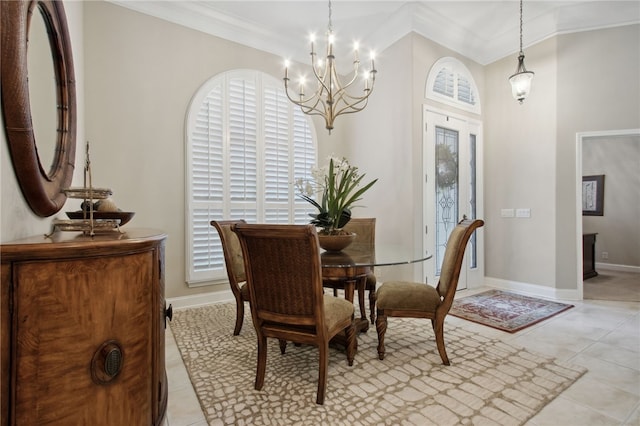 dining area featuring ornamental molding, light tile patterned floors, and an inviting chandelier