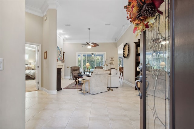 tiled living room with ceiling fan and ornamental molding