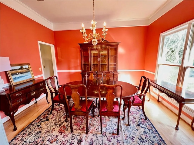 145 Shore Rush Dr, Saint Simons Island, GA 31522 - dining space with a chandelier, ornamental molding, and wood finished floors