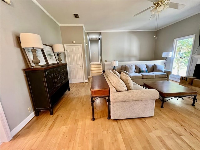 living room featuring ceiling fan, light hardwood / wood-style floors, and ornamental molding