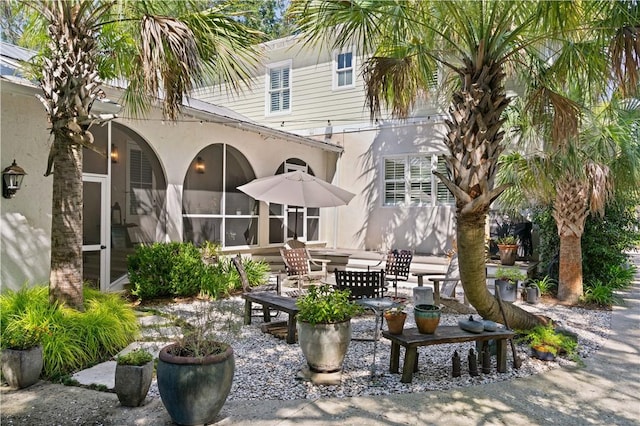 view of patio / terrace featuring a sunroom