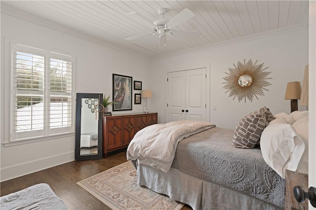 bedroom featuring ceiling fan, wooden ceiling, dark hardwood / wood-style floors, a closet, and ornamental molding