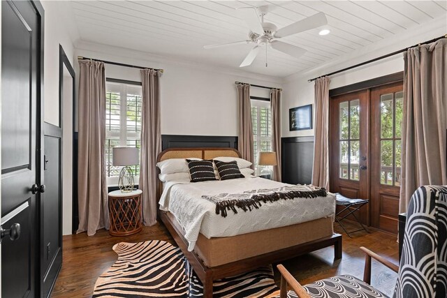 bedroom with ceiling fan, french doors, dark wood-type flooring, and multiple windows