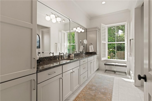 bathroom with tile patterned floors, vanity, and crown molding