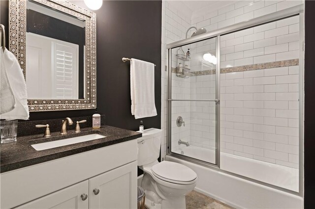 full bathroom with vanity, toilet, and enclosed tub / shower combo