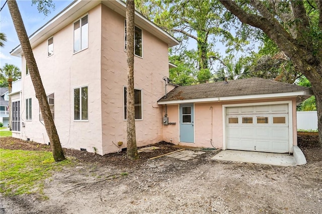 4206 Tenth St, Saint Simons Island, GA 31522 - view of side of property featuring stucco siding and a garage
