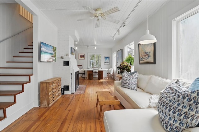 4206 Tenth St, Saint Simons Island, GA 31522 - living room featuring track lighting, light wood-style floors, stairway, and ceiling fan