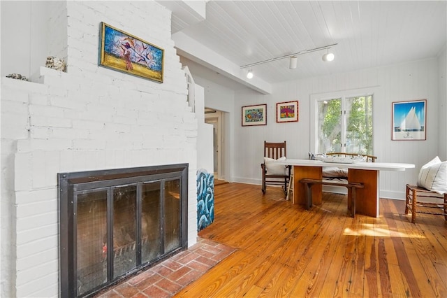 4206 Tenth St, Saint Simons Island, GA 31522 - dining room with hardwood / wood-style floors, track lighting, a brick fireplace, and wooden ceiling