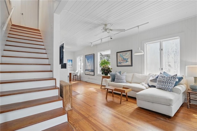4206 Tenth St, Saint Simons Island, GA 31522 - living area with stairs, light wood-style floors, and plenty of natural light