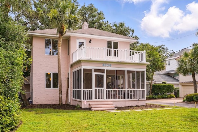 4206 Tenth St, Saint Simons Island, GA 31522 - back of property featuring a balcony, a sunroom, stucco siding, a yard, and a chimney