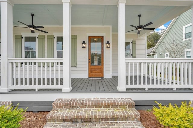 entrance to property with a porch and a ceiling fan