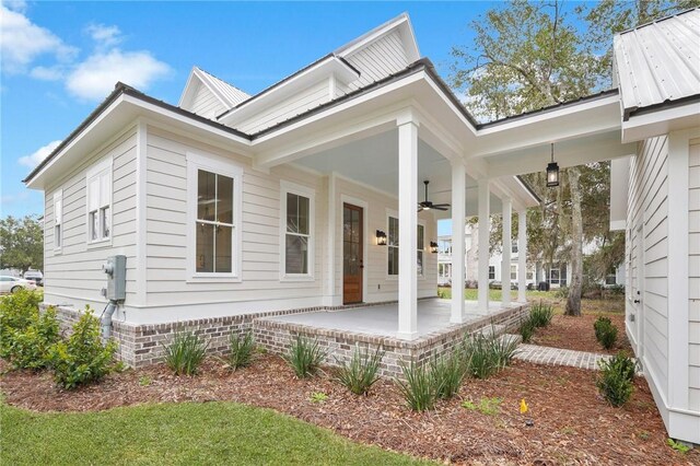 exterior space featuring ceiling fan, a porch, and metal roof