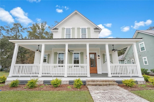 farmhouse-style home featuring a porch and ceiling fan