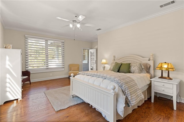 bedroom with hardwood / wood-style floors, ceiling fan, and ornamental molding