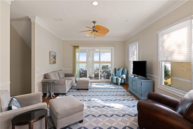 living room with light hardwood / wood-style flooring, ceiling fan, and ornamental molding