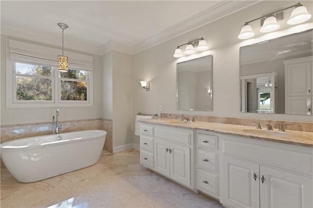 bathroom featuring vanity, crown molding, and a tub