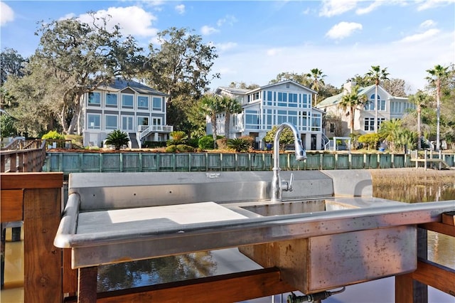 exterior space with a water view and a dock