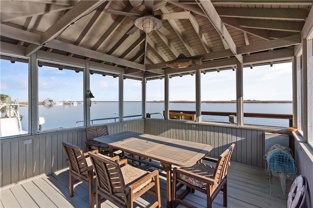 sunroom / solarium with vaulted ceiling with beams, a water view, and a healthy amount of sunlight