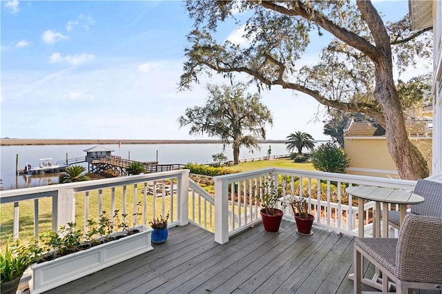 deck featuring a yard and a water view