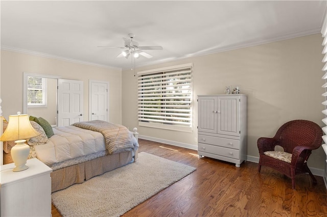 bedroom with ceiling fan, dark hardwood / wood-style floors, crown molding, and multiple windows