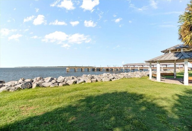 dock area with a yard, a gazebo, and a water view