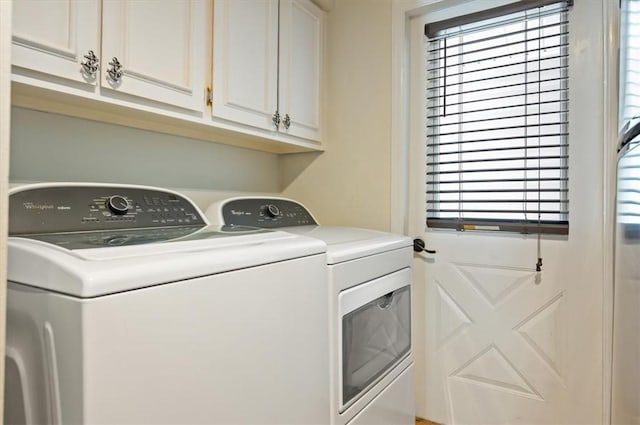 laundry area featuring cabinets and washing machine and clothes dryer