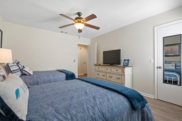 bedroom featuring ceiling fan and light hardwood / wood-style floors