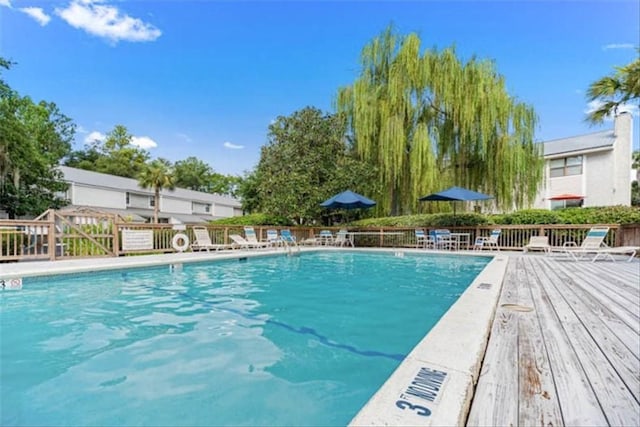 view of swimming pool with a wooden deck