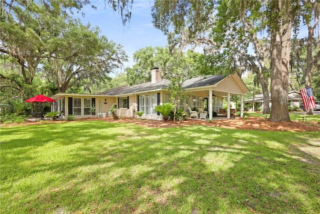 1152 Julienton Lndg NE, Townsend, GA 31331 - back of property featuring a chimney and a yard