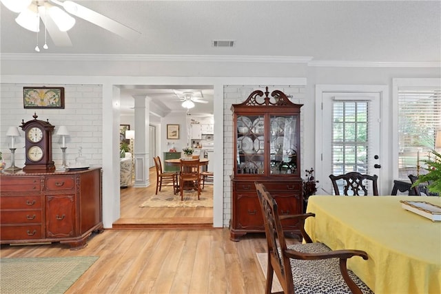 1152 Julienton Lndg NE, Townsend, GA 31331 - dining room with ceiling fan, light wood finished floors, ornamental molding, and ornate columns