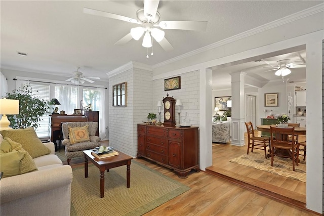 1152 Julienton Lndg NE, Townsend, GA 31331 - living area featuring a ceiling fan, light wood finished floors, ornamental molding, and ornate columns