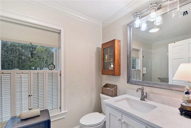 bathroom with vanity, toilet, and ornamental molding