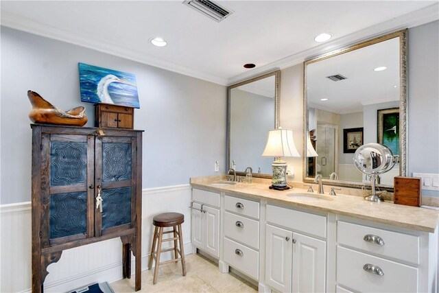 bathroom featuring crown molding and vanity