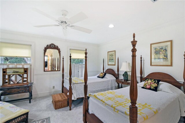 bedroom with ceiling fan, crown molding, and light colored carpet