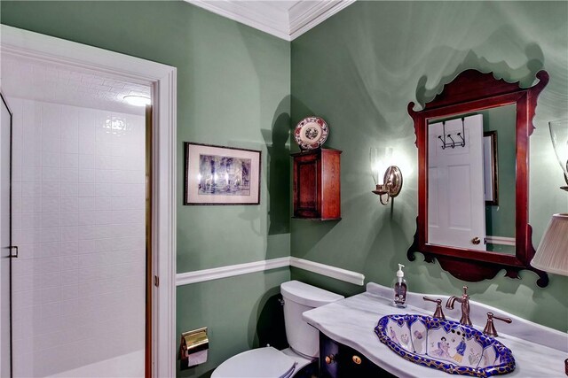 bathroom with vanity, toilet, and ornamental molding