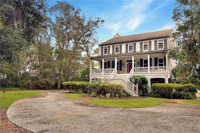 colonial-style house featuring covered porch