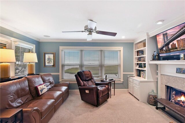 living room featuring light carpet, built in features, ceiling fan, and ornamental molding