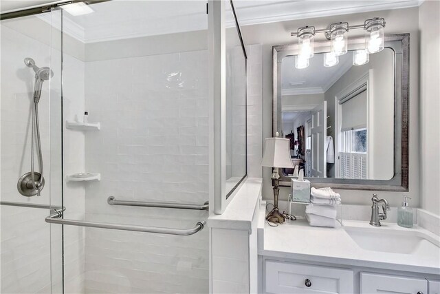 bathroom featuring vanity, an enclosed shower, and ornamental molding