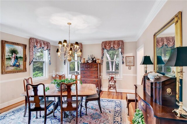 dining room featuring crown molding, wood-type flooring, and a notable chandelier